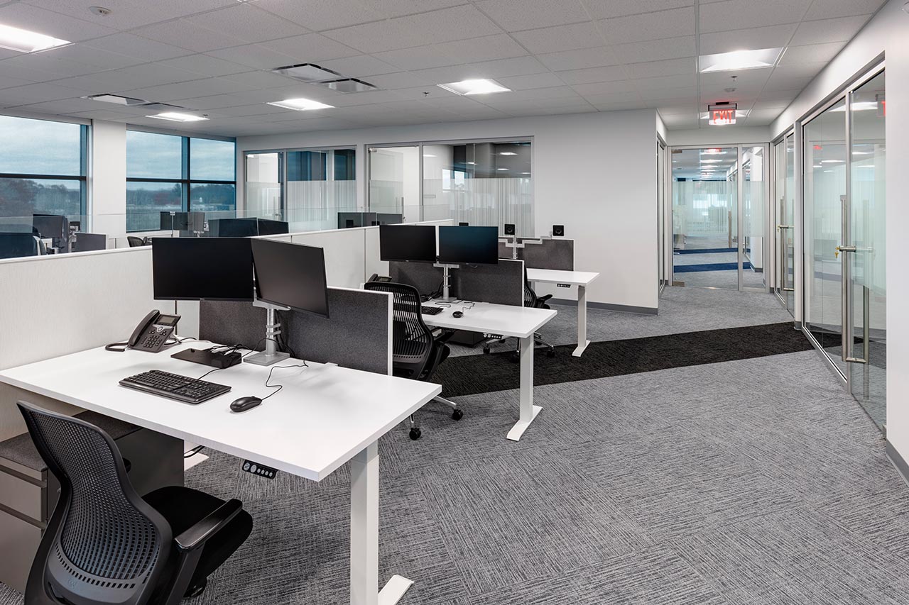 Open office area flanked by glass enclosed private offices